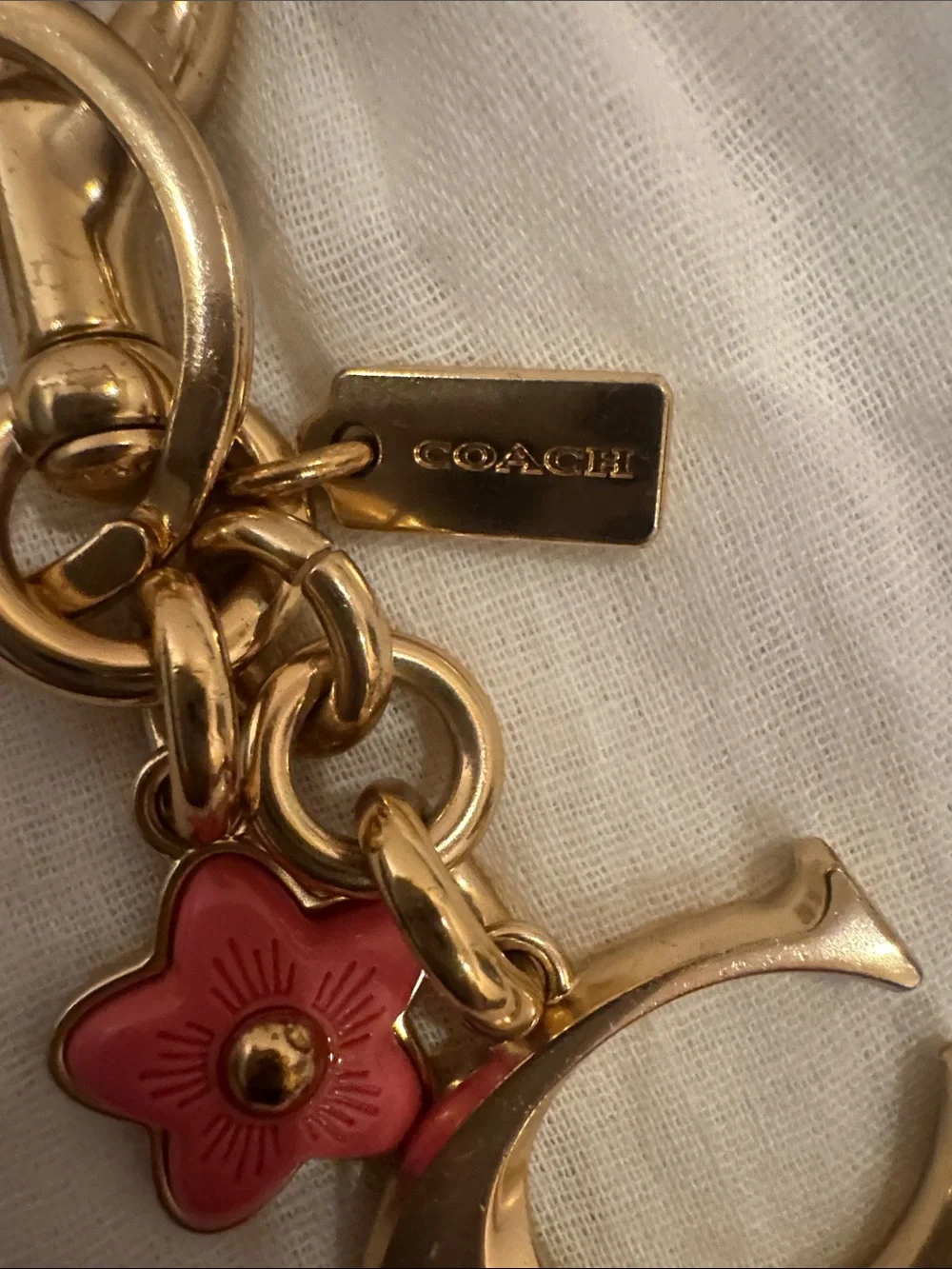 NWOT, Coach vintage gold “C” key fob/ bag charm in gold .